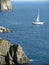 Sailboat along a Rocky Coast