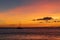 Sailboat anchored in a Maui channel during a beautiful Hawaiian sunset