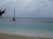 A sailboat anchoring in the windward islands