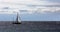 Sailboat on the Atlantic Ocean under a cloudy sky.