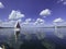 Sailboat on beautiful lake on blue sky and pleasant green landscape background and lovely reflection on water surface.