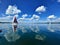 Sailboat on beautiful lake on blue sky and pleasant green landscape background and lovely reflection on water surface. Sailing is