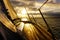 Sailboat with beautiful morning sky visible from side deck, in action on the water.