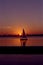 Sailboat on Boston Charles River Basin sailing at Sunset with MIT campus in the background