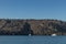 sailboat with cliff behind in the sea of santorini.