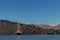 sailboat with cliff behind in the sea of santorini.