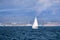 Sailboat close to the Pacific Ocean coastline near Moss Landing