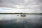 Sailboat cruising with furled sails on Australian lake