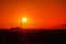 A sailboat and a ferryboat crossing the San Francisco Bay at sunset with the Golden Gate Bridge in the background.