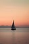 Sailboat floating on a calm lake, hazy background