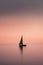 Sailboat floating on a calm lake, hazy background