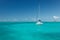 Sailboat floating on gorgeous tropical waters in Caribbean Sea