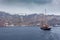 Sailboat heading towards the port of Fira village, Santorini Island