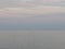 Sailboat at horizon line at sunset light