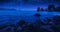 Sailboat on a horizon in mediterranean sea bay at night
