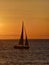 Sailboat on the ionic sea at sunset