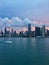 Sailboat on Lake Michigan with Chicago skyline in background during stunning sunset.