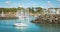 Sailboat leaves the marina of Bourgenay Harbor