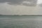 Sailboat in the middle of the ocean on a stormy rainy day