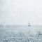 Sailboat on Misty Blue Seas
