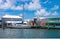 Sailboat moored near colorful houseboats at a marina near Key West.