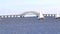 Sailboat moving in front of the Great South Bay Bridge in West Islip New York