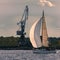 Sailboat moving past the cargo crane