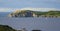 Sailboat navigates near Twillingate cliffs, seascape, landscape, Newfoundland, Atlantic Canada.