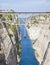 Sailboat navigating the narrow Canal of Corinth, in Greece.