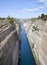 Sailboat navigating the narrow Canal of Corinth, in Greece.