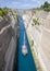 Sailboat navigating the narrow Canal of Corinth, in Greece.