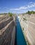 Sailboat navigating the narrow Canal of Corinth, in Greece.