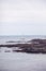 Sailboat near Oarweed Cove along the rocky coast of Maine in Ogunquit