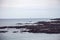 Sailboat near Oarweed Cove along the rocky coast of Maine in Ogunquit