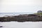 Sailboat in Oarweed Cove on Marginal way path along the rocky coast of Maine in Ogunquit