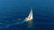 Sailboat in the ocean. White sailing yacht in the middle of the boundless ocean. Aerial view.