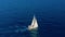 Sailboat in the ocean. White sailing yacht in the middle of the boundless ocean. Aerial view.