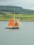 Sailboat with Orange Sails on the Sound of Mull, Scotland, UK.