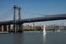 Sailboat passes under the Williamsburg bridge. New York City