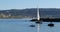 Sailboat passing the harbor breakwater into the Pacific ocean