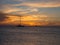 Sailboat passing through a sunset