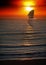 Sailboat on peaceful sea under the sunrise
