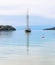 Sailboat reflected on sea at Porto Heli beach Argolis Greece