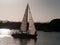 Sailboat returning to the marina at sunset