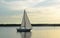 Sailboat on river at dusk