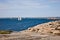 Sailboat and rocky coast