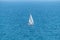 Sailboat sailing alone in vast blue Gulf of Mexico off the coast of Panama City Beach Florida