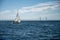 A sailboat sailing in front of the Oresund bridge linking Denmark with Sweden. Blue ocean and sky