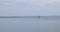 A sailboat sails on the lake. Natural monochrome background