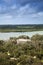 Sailboat sails through Ponce de Leon Inlet in an aerial view of New Smyrna Beach